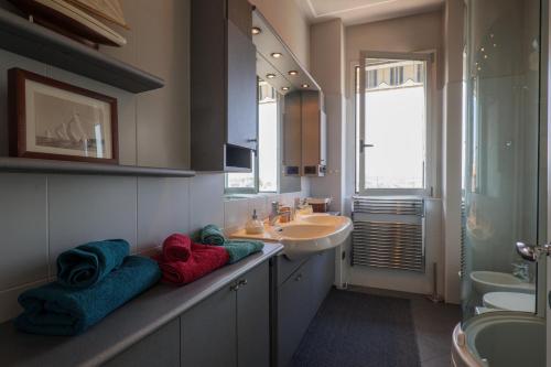 a bathroom with a sink and a counter with towels at L’Attico di Susanna in Verbania