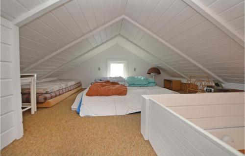 a attic bedroom with two beds and a window at Awesome Home In Svendborg With Kitchen in Thurø By