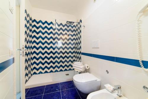 a bathroom with a toilet and a sink at Sharon House in Amalfi