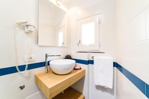 ein Badezimmer mit einem Spülbecken auf einer Holztheke in der Unterkunft Sharon House in Amalfi