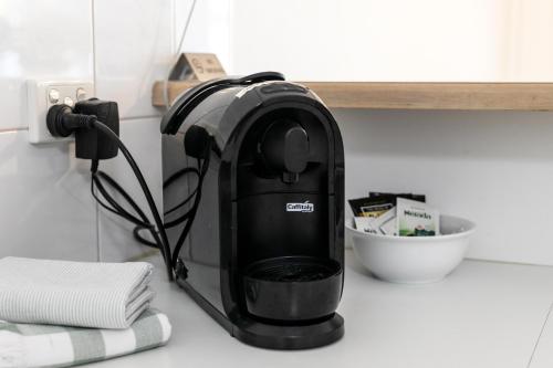 a coffee maker on a counter in a kitchen at Noosa Sunseeker-walk to cafes & river, pet friendly in Noosaville