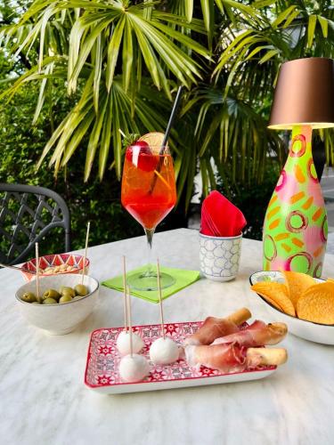 a table with a plate of food and a drink at Hotel Rovereto in Rovereto