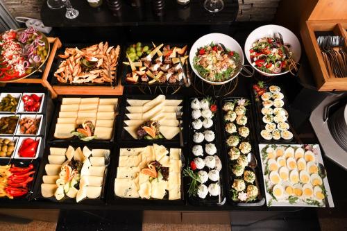 a table with many different types of food on it at Meta Apartments in Szczyrk
