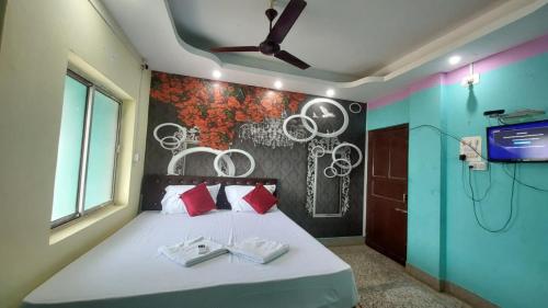 a bedroom with a bed with two towels on it at Goroomgo J K Inn Puri Sea View Room in Puri