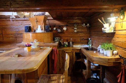 a kitchen with wooden counters and a large wooden table at Wooden love nest in Vransko