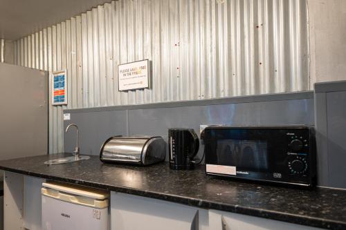 a microwave sitting on a counter in a kitchen at Urban Nomad - Camden Town in London