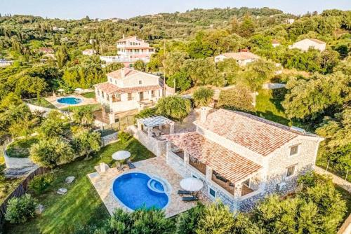 an aerial view of a house with a swimming pool at Villa Dias in Agios Ioannis