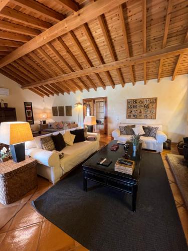 a living room with a couch and a table at Villa Malveira in Alcabideche