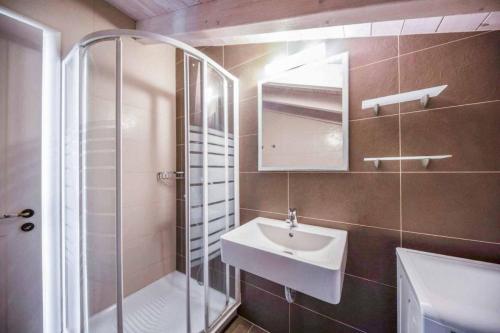 a bathroom with a shower and a sink and a mirror at Villa Gialetti in Almiros Beach
