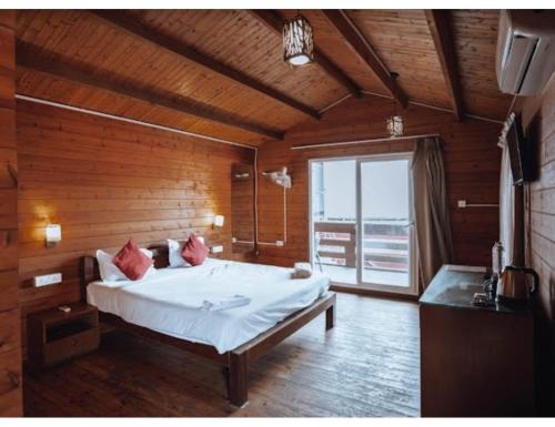 a bedroom with a large bed in a wooden room at R K Habbana Beach Resort, Baga, Goa in Baga