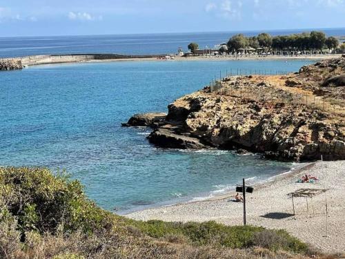 a beach with people on the sand and the water at Harbour lights by Smaris Collection in Sissi