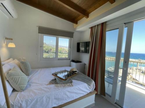 a bedroom with a bed with a view of the ocean at Harbour lights by Smaris Collection in Sisi