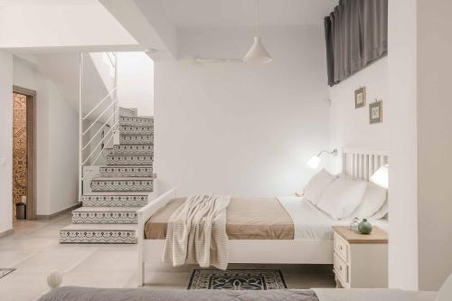 a bedroom with a bed and a staircase at Villa Seashell Skala in Spathíon