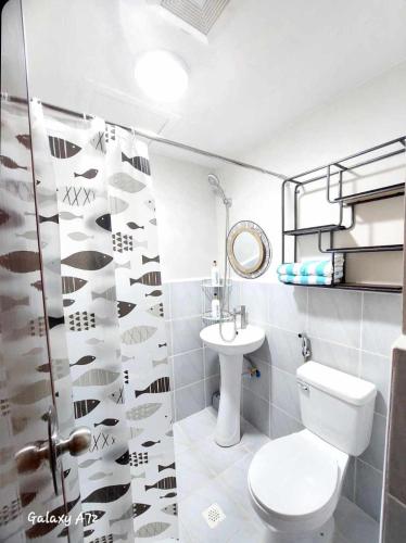 a bathroom with a toilet and a sink at Jena Staycation in Lapu Lapu City