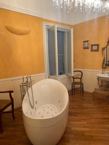 a bathroom with a large tub in a room at Gold Genova Carbonara in Genova