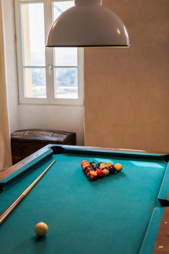a pool table with cue balls on top of it at Domaine de la Cascade Parfumée in Grasse