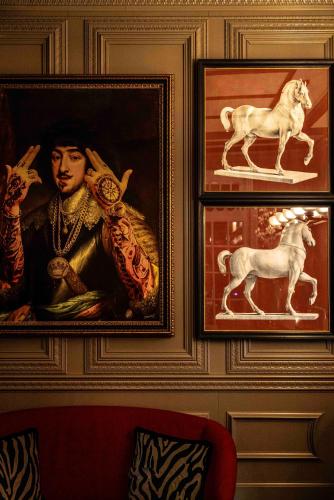 a painting of a man and horses on a wall at Maalot Roma - Small Luxury Hotels of the World in Rome