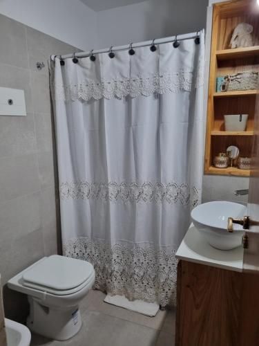 a bathroom with a toilet and a shower curtain at Elegante 3 dormitorios in Buenos Aires
