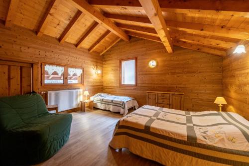 a bedroom with two beds in a wooden cabin at Gîte Tournette in Thônes