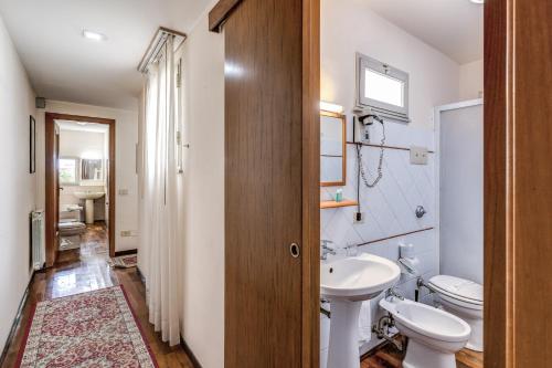a bathroom with a toilet and a sink at Hotel La Residenza in Messina