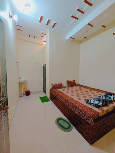 a bedroom with a large bed in a white room at Aayu Parth Residency 300 M from Ram Janam Bhumi in Ayodhya