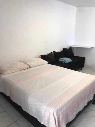 En eller flere senge i et værelse på Arraial suíte