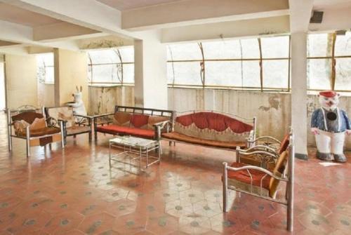 a room filled with lots of furniture and windows at Hotel Jai Palace Wardha in Wardha