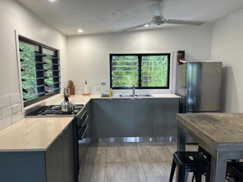 a large kitchen with a sink and a stove at Stonewood Views in Diwan