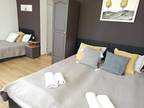 a bedroom with a bed with towels on it at Guest House Sunflowers in Pomorie