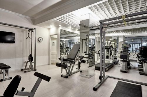 a gym with several treadmills and cardio machines at Rouge Hotel International in Milano Marittima