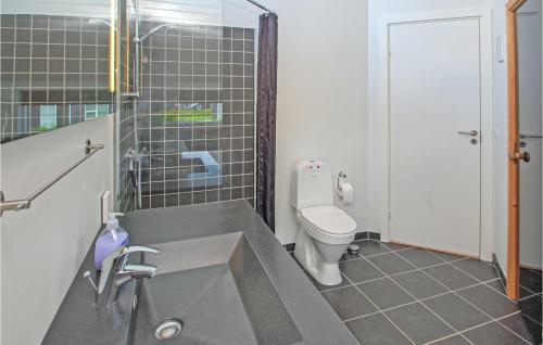a bathroom with a sink and a toilet in it at Holiday Home Flovt Havevej Ix in Flovt