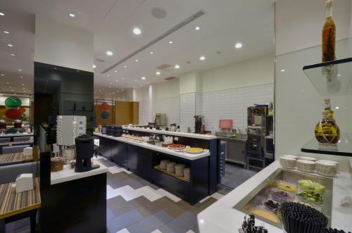 a large kitchen with a buffet in a restaurant at C U Hotel Taichung in Taichung