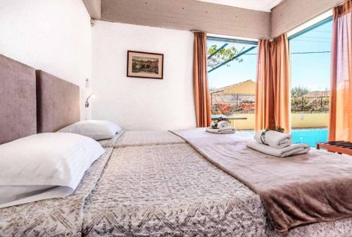 a bedroom with a large bed with a large window at Villa Zante in Barbati