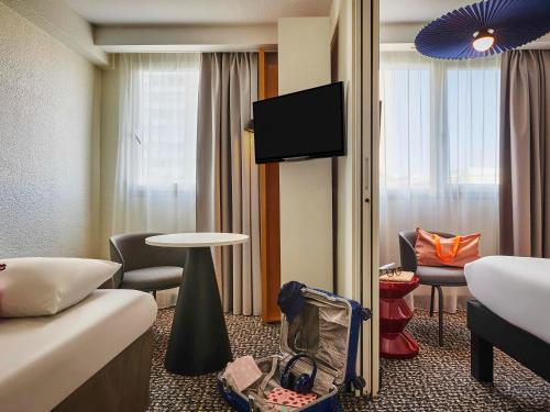 a hotel room with a bed and a tv at ibis Paris Avenue d'Italie 13ème in Paris