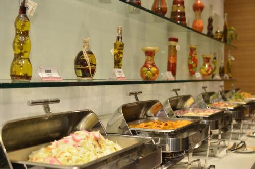 a buffet line with trays of food on display at C U Hotel Taichung in Taichung