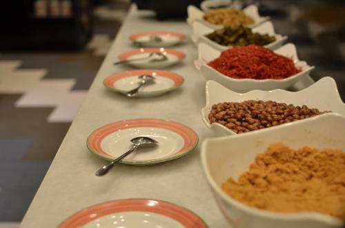 a long table topped with bowls of food and spoons at C U Hotel Taichung in Taichung