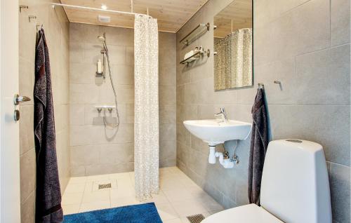 a bathroom with a toilet and a sink at Lovely Home In Bogense With House Sea View in Bogense