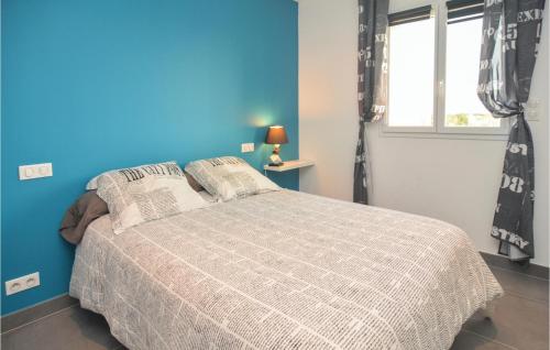 Schlafzimmer mit einem Bett mit blauer Wand in der Unterkunft Lovely Home In Saint-gilles With Wifi in Saint-Gilles