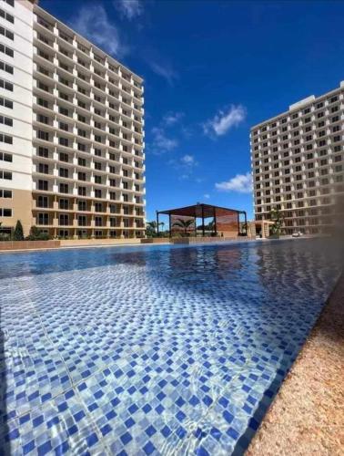 a swimming pool in front of two buildings at Seo staycation in Lapu Lapu City