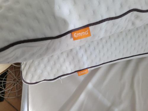 a mattress with orange labels on top of it at F2 cosy avec Cour in Milly-la-Forêt