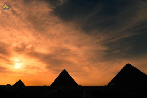 a kite flying in the sky at sunset at Egypt Pyramids Inn in Cairo