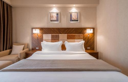 a hotel room with a large bed and a couch at Dreamland Oasis Hotel in Chakvi