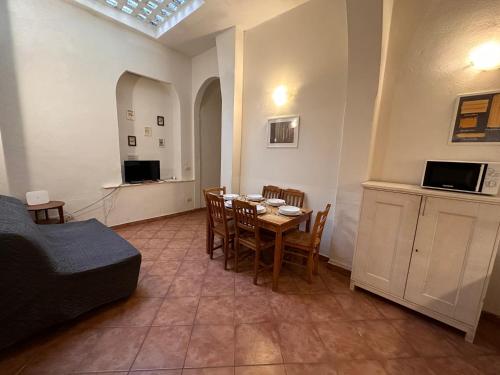 a living room with a table and chairs and a couch at A Due Passi Dall'Accademia in Florence