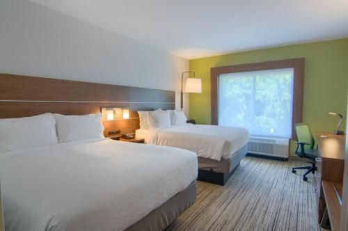 a hotel room with two beds and a window at Holiday Inn Express & Suites Mobile - University Area, an IHG Hotel in Mobile