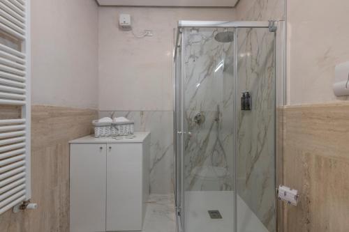 a shower with a glass door in a bathroom at Milan Royal Suites - Centro in Milan