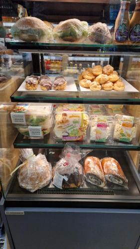 a display case with different types of bread and pastries at APARTAMENT JARACZA 28/10 in Słupsk