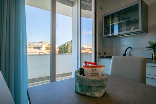 a kitchen with a view of a large window at Milena Suite Apartments in Alghero