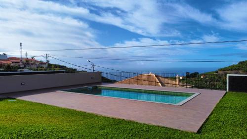 a swimming pool on the side of a house at Allure Alannas Villa by LovelyStay in Funchal