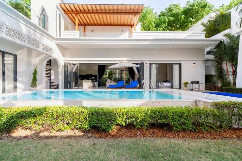 a swimming pool in the backyard of a house at Menara - 3 BR Private Pool Villa - Moroccan Inspired - Bangtao Beach in Phuket