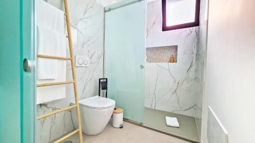a bathroom with a shower with a toilet and a ladder at Allure Alannas Villa by LovelyStay in Funchal